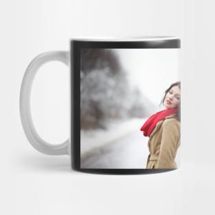 Beautiful brunette with hair blown by wind in the winter Mug